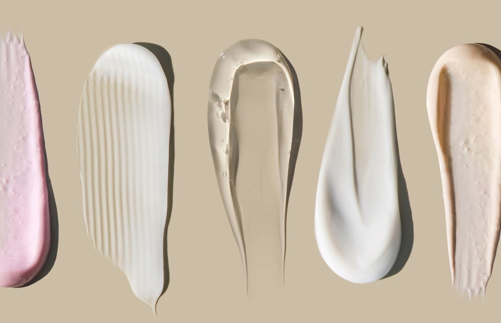 cosmetic smears cream texture on pastel background